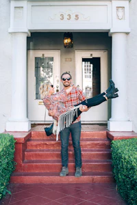 a man and woman standing on the steps of a house