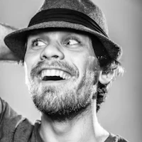 a black and white photo of a man in a hat